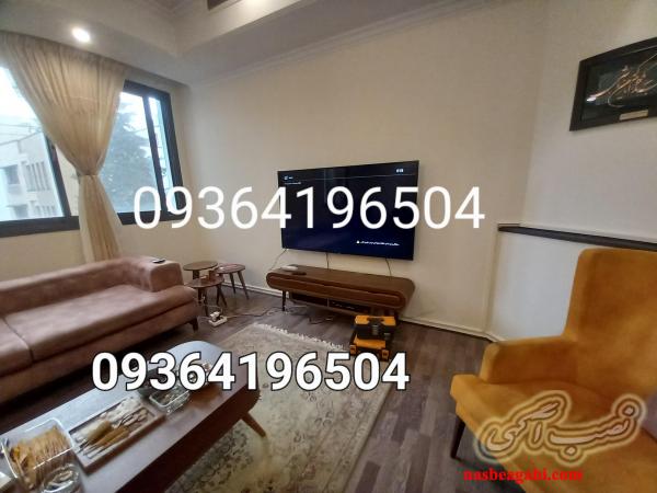 نصاب تلویزیون روی دیوار در تهران